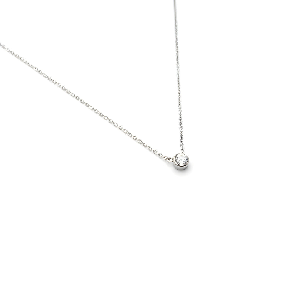 Delicate white gold necklace with a small round diamond pendant